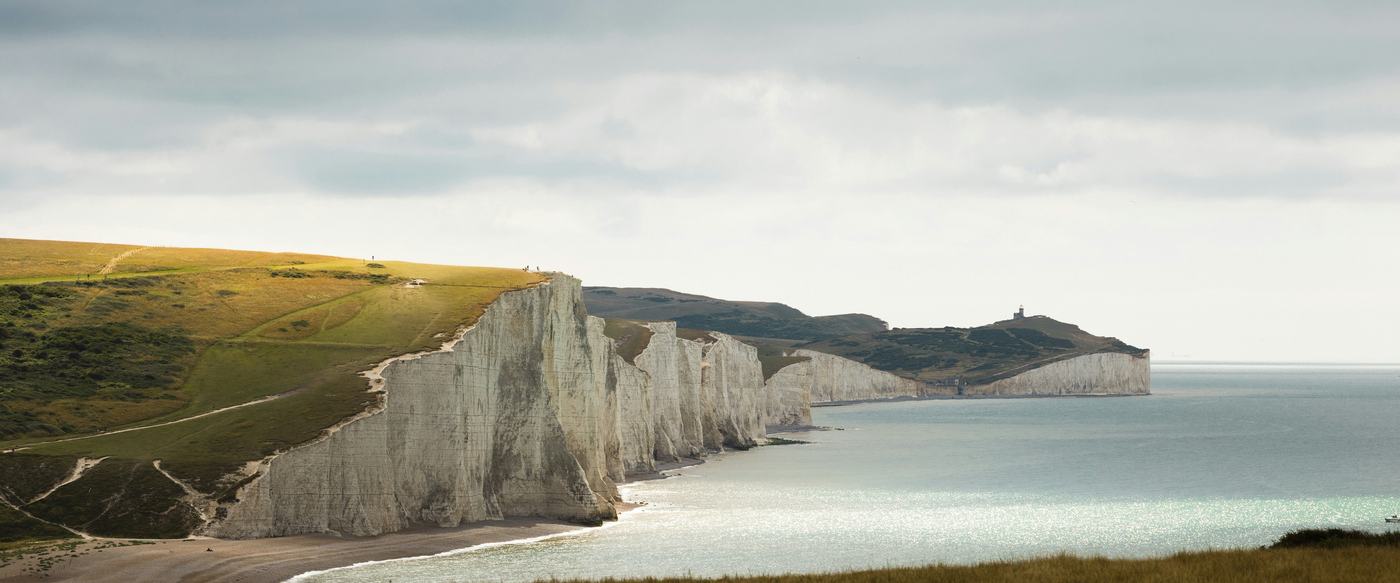 The Seven Sisters chalk cliffs on the Sussex coast under a grey sky